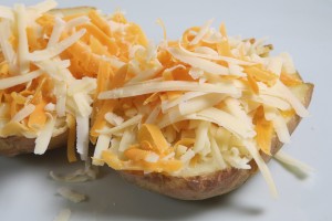 Baked potato topped with grated Cheddar and Red Leiceister cheeses